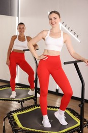Photo of Smiling women on mini exercise trampolines in fitness studio