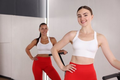 Photo of Smiling women on mini exercise trampolines in fitness studio