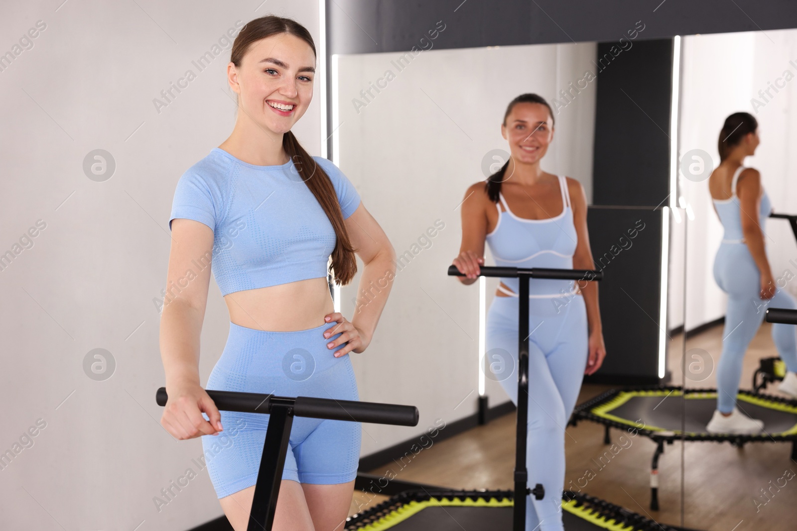 Smiling women on mini exercise trampolines in fitness studio Photo of Smiling women on mini exercise trampolines in fitness studio