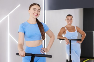 Photo of Smiling women on mini exercise trampolines in fitness studio