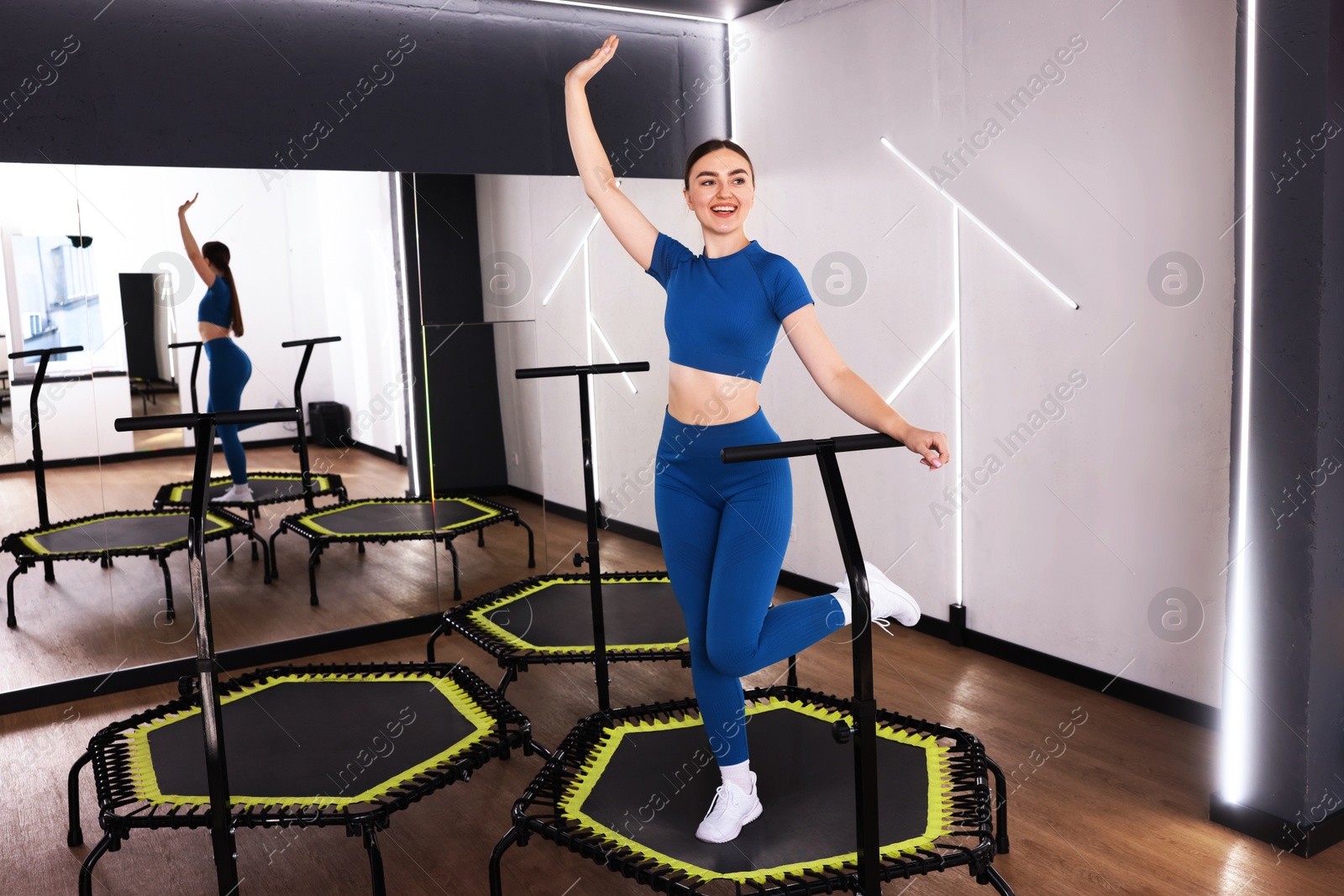Smiling woman training on mini exercise trampoline in fitness studio Photo of Smiling woman training on mini exercise trampoline in fitness studio
