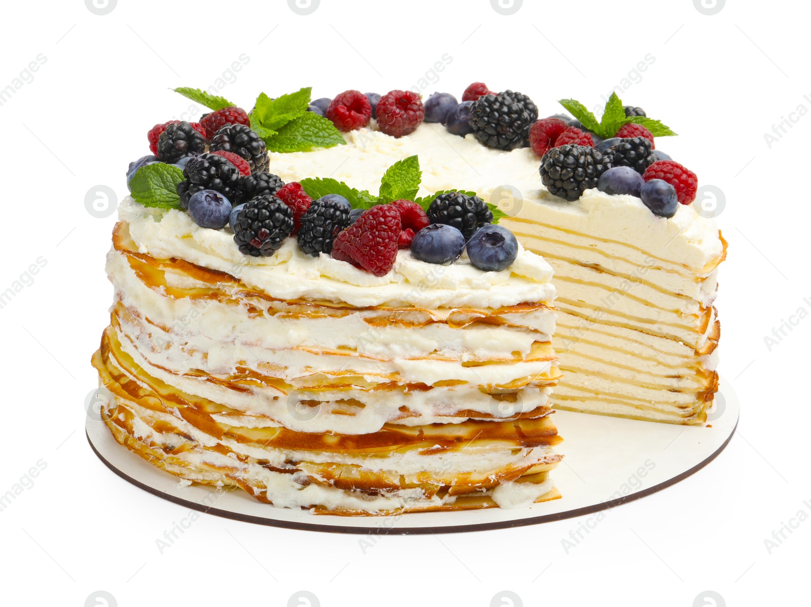 Photo of Tasty crepe cake with berries and mint isolated on white