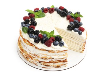Photo of Tasty crepe cake with berries and mint isolated on white
