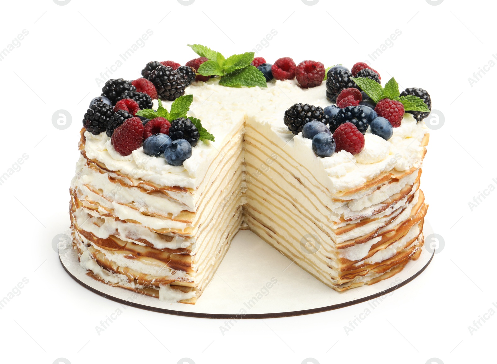 Photo of Tasty crepe cake with berries and mint isolated on white