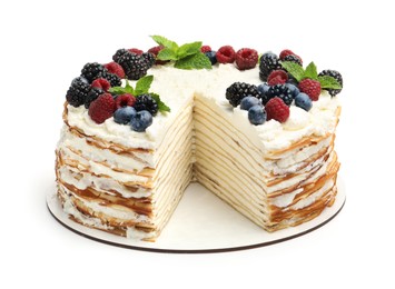 Photo of Tasty crepe cake with berries and mint isolated on white