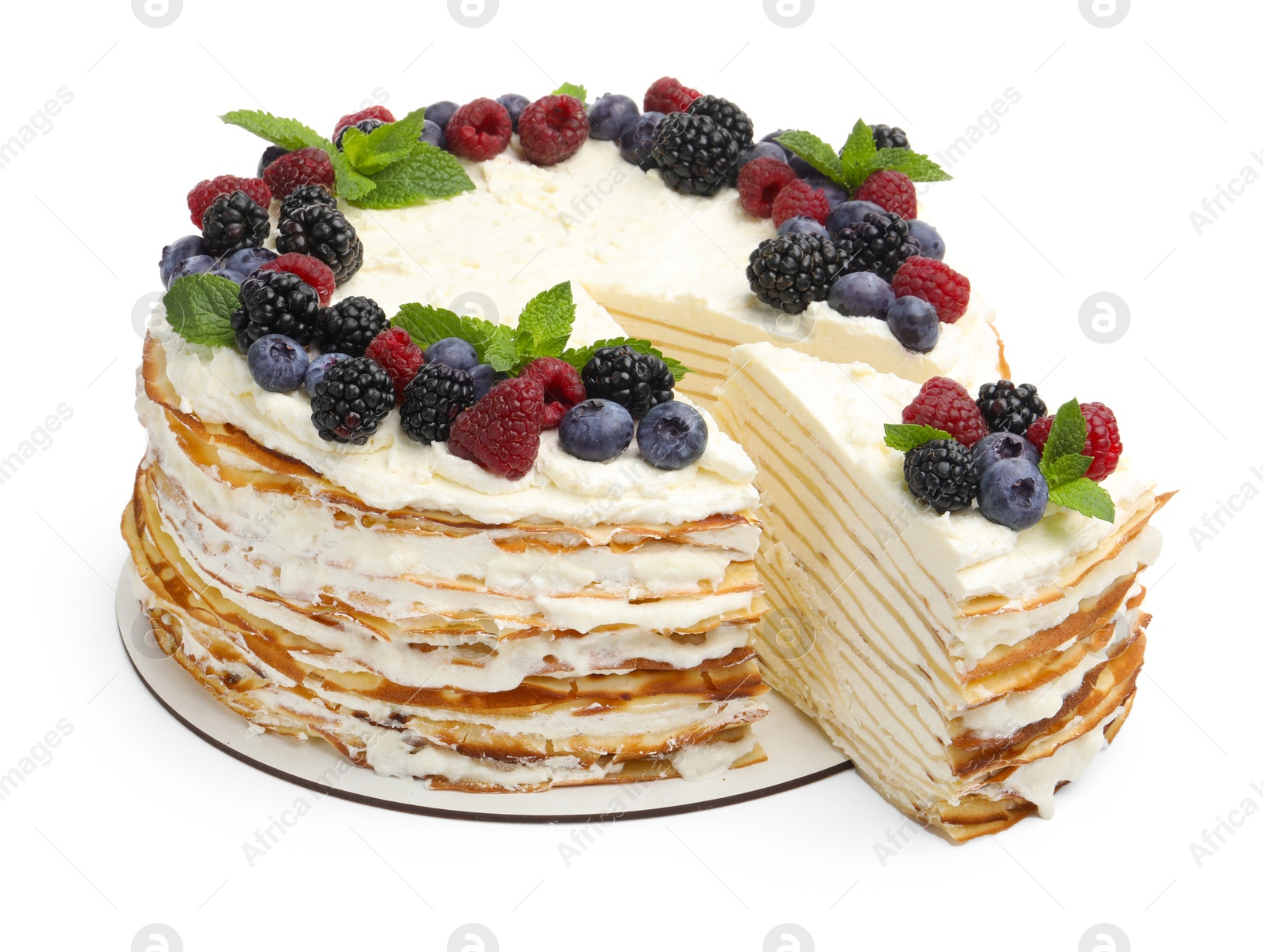 Photo of Tasty crepe cake with berries and mint isolated on white