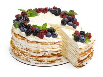 Photo of Tasty crepe cake with berries and mint isolated on white