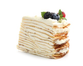 Photo of Piece of tasty crepe cake with berries and mint isolated on white