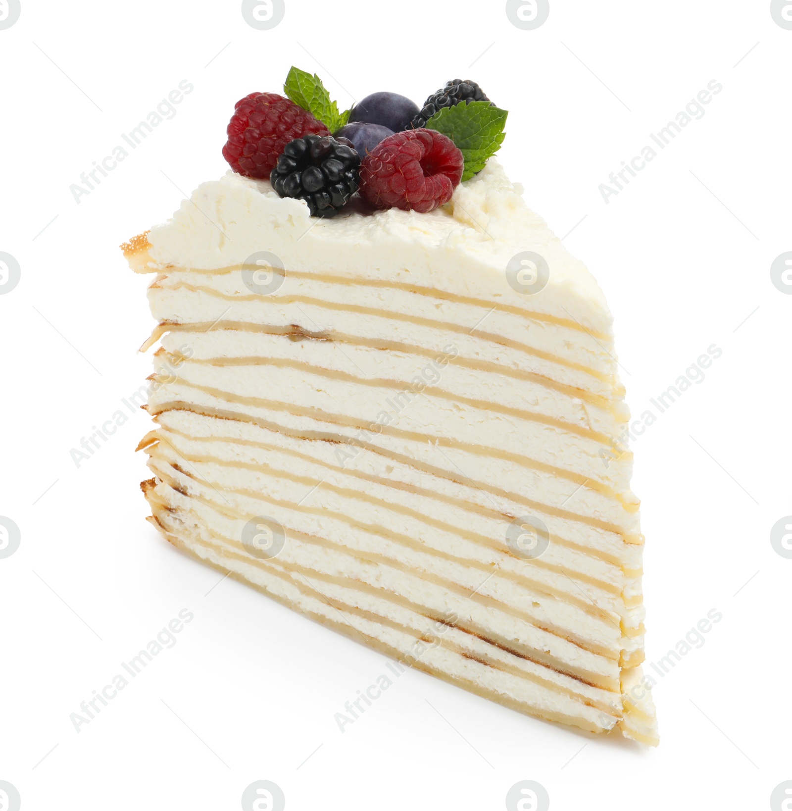 Photo of Piece of tasty crepe cake with berries and mint isolated on white
