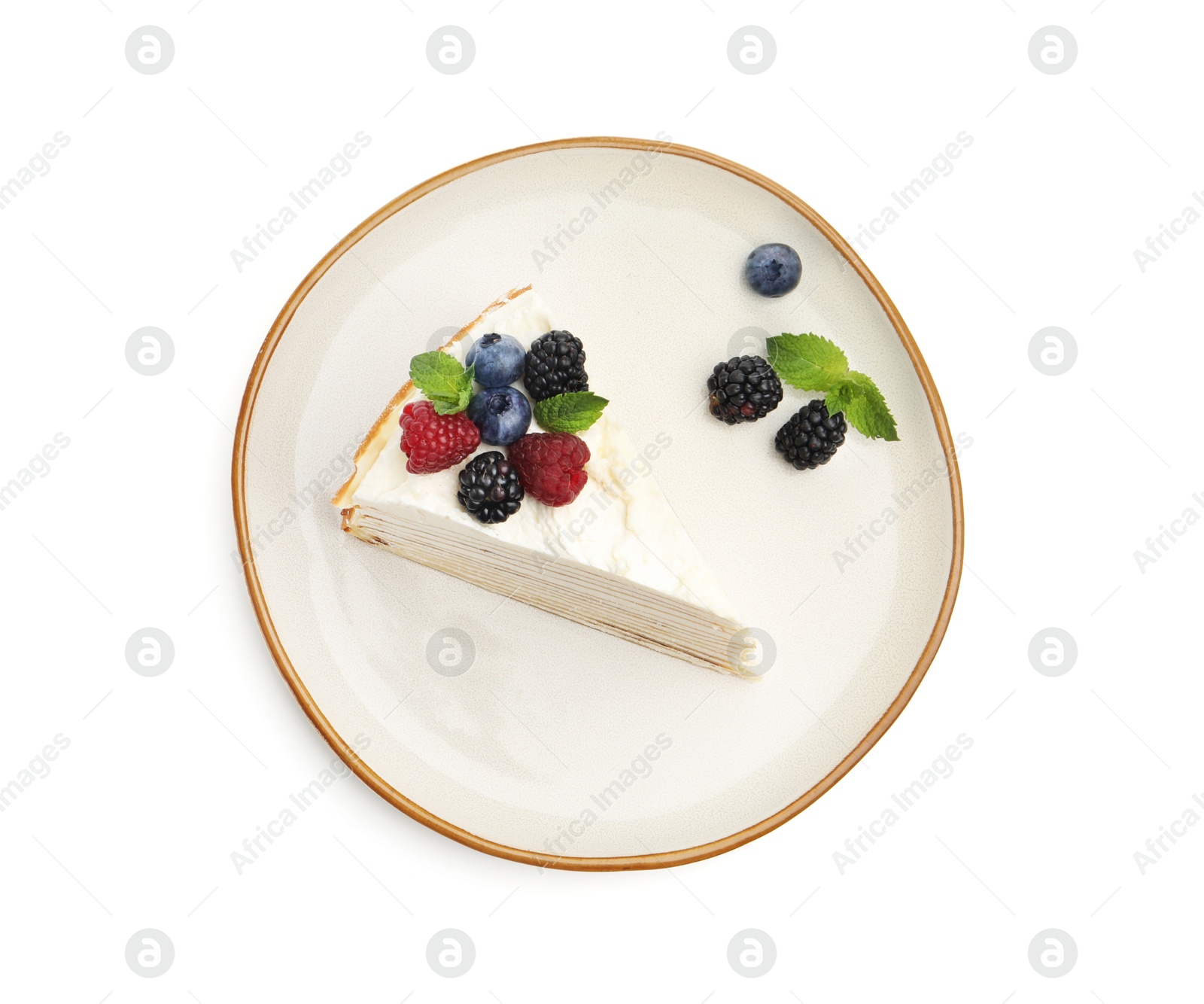 Photo of Piece of tasty crepe cake with berries and mint isolated on white, top view