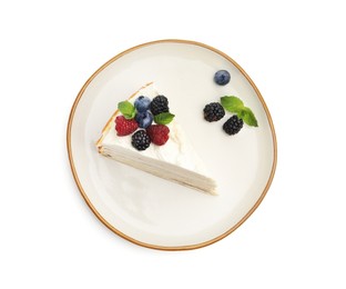 Photo of Piece of tasty crepe cake with berries and mint isolated on white, top view