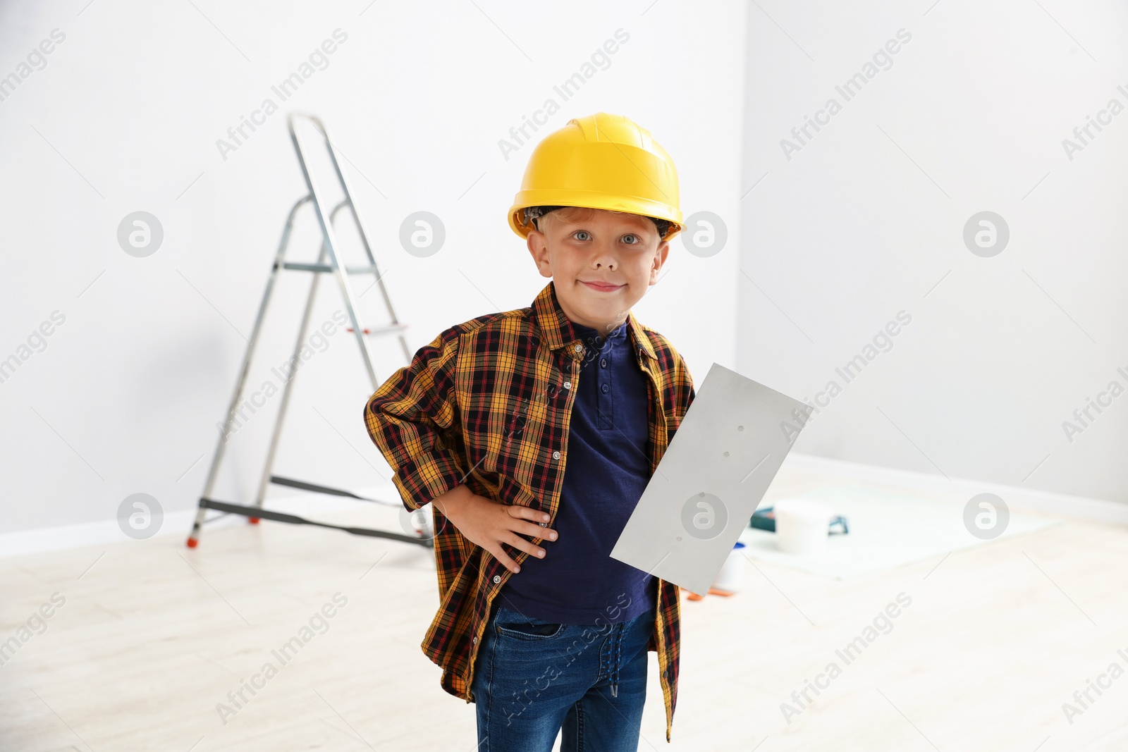 Choice of profession. Little boy with spatula tool pretending to be builder indoors Photo of Choice of profession. Little boy with spatula tool pretending to be builder indoors