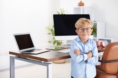 Photo of Choice of profession. Little boy pretending to work in office