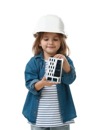Photo of Choice of profession. Little girl in hardhat with building model pretending to be architect on white background
