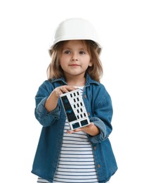 Photo of Choice of profession. Little girl in hardhat with building model pretending to be architect on white background