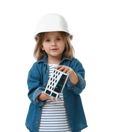 Photo of Choice of profession. Little girl in hardhat with building model pretending to be architect on white background