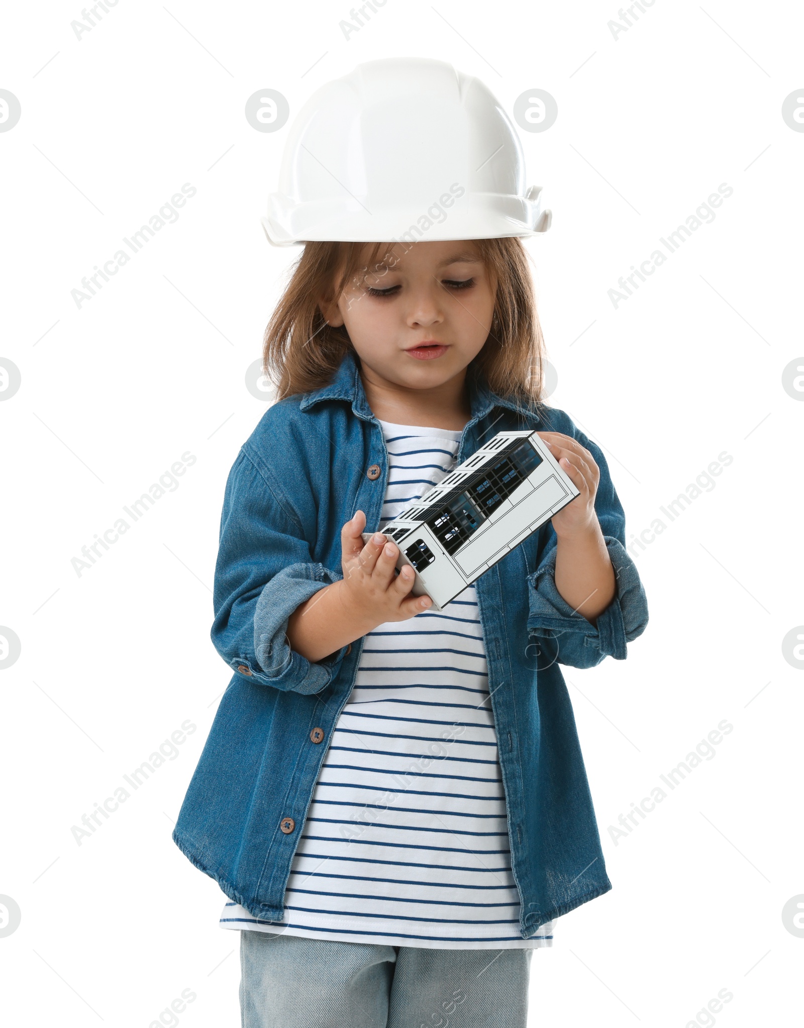 Photo of Choice of profession. Little girl in hardhat with building model pretending to be architect on white background