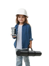 Photo of Choice of profession. Little girl in hardhat with building model and drawing tube pretending to be architect on white background