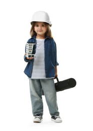 Photo of Choice of profession. Little girl in hardhat with building model and drawing tube pretending to be architect on white background