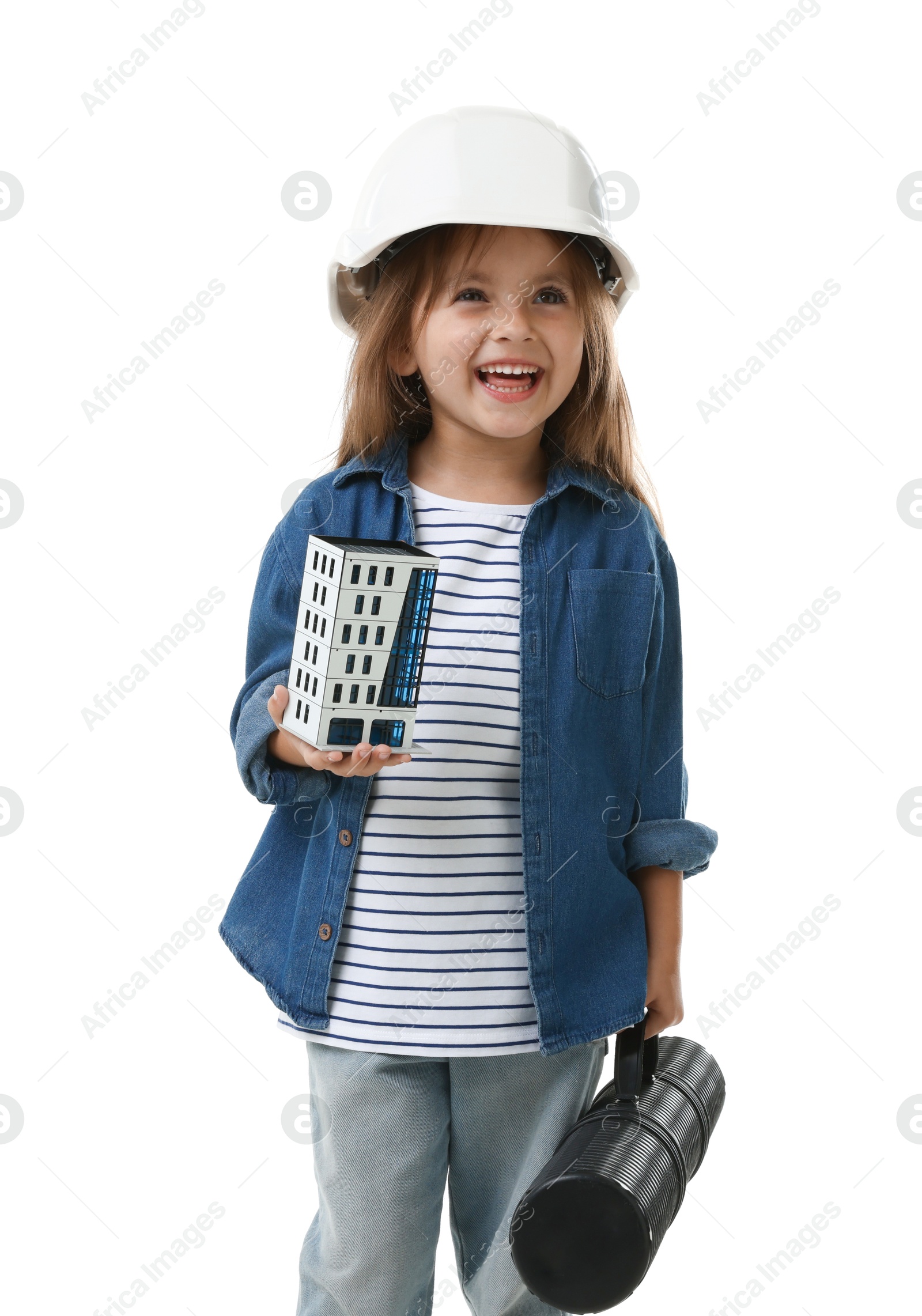 Photo of Choice of profession. Little girl in hardhat with building model and drawing tube pretending to be architect on white background