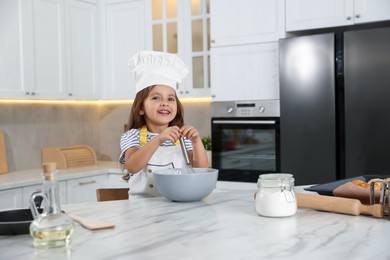 Photo of Choice of profession. Little girl pretending to be chef in kitchen