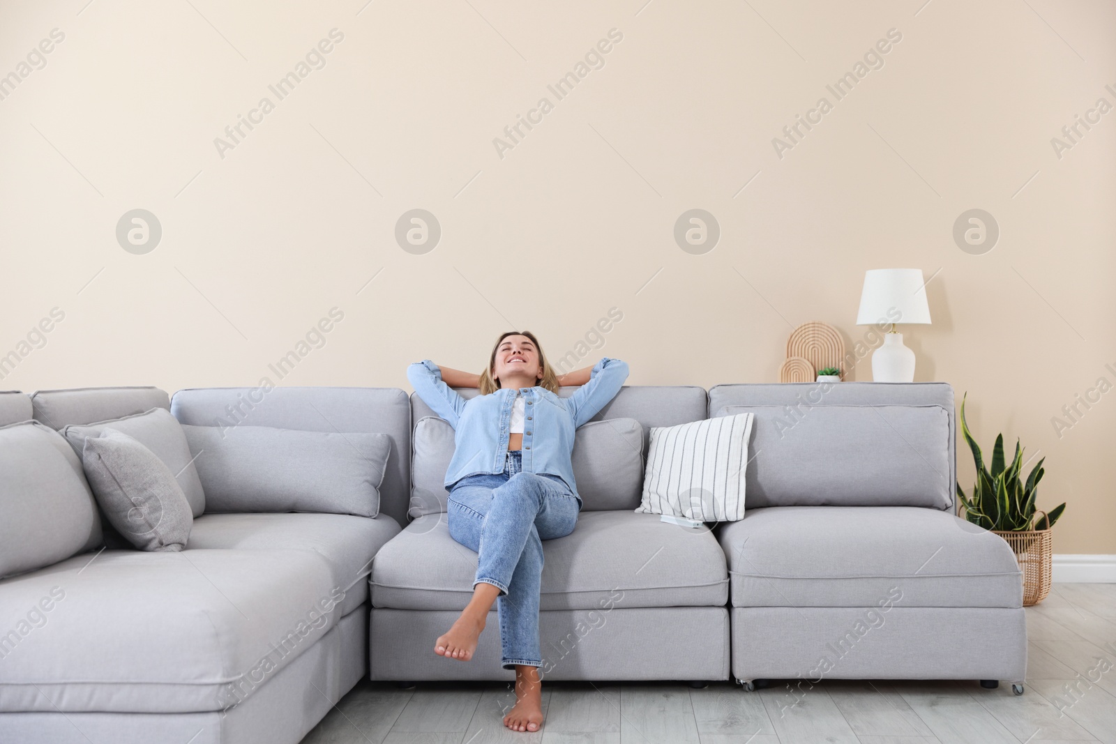 Beautiful woman relaxing on sofa at home Photo of Beautiful woman relaxing on sofa at home