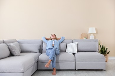 Photo of Beautiful woman relaxing on sofa at home
