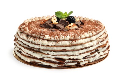 Photo of Delicious crepe cake with chocolate, nuts, blackberries and cocoa powder isolated on white