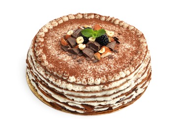 Photo of Delicious crepe cake with chocolate, nuts, blackberries and cocoa powder isolated on white