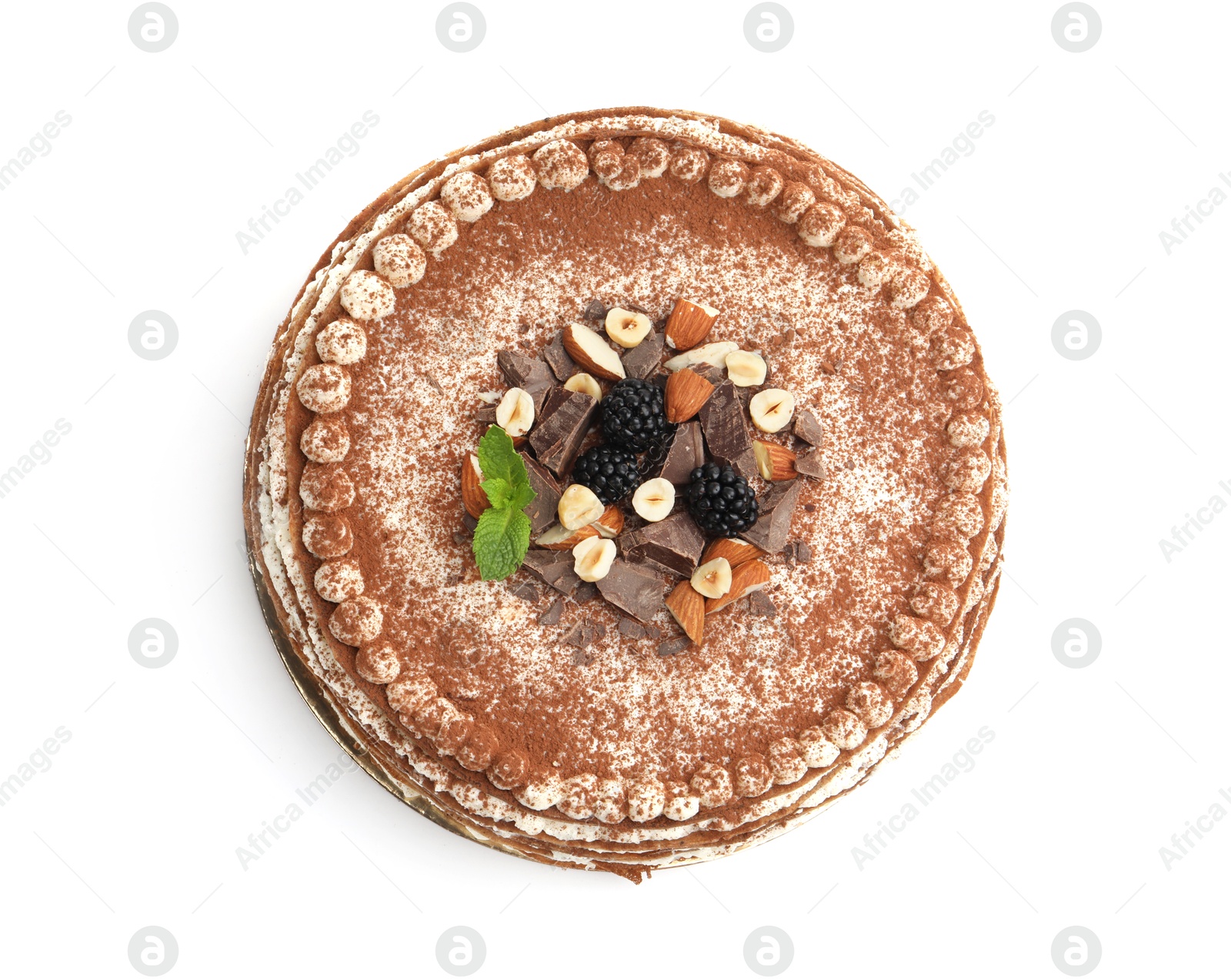 Photo of Delicious crepe cake with chocolate, nuts, blackberries and cocoa powder isolated on white, top view