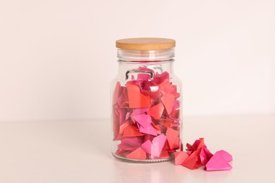 Photo of Color paper pieces in glass jar on light table