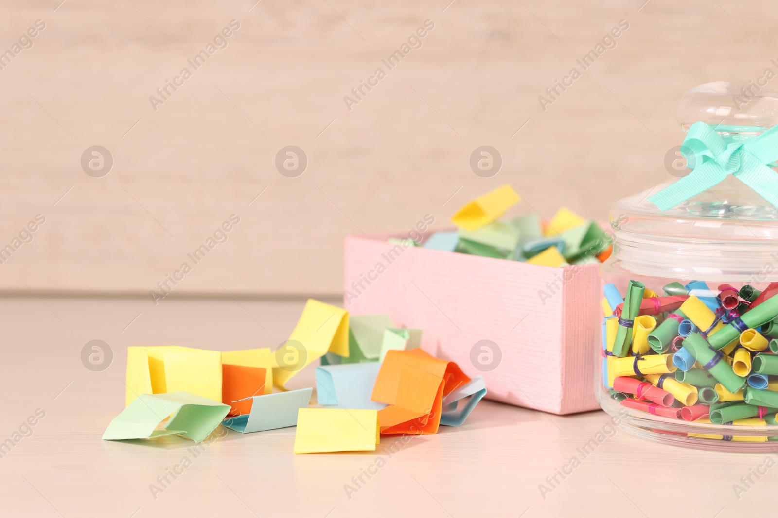 Color paper pieces on light wooden table, closeup. Space for text Photo of Color paper pieces on light wooden table, closeup. Space for text