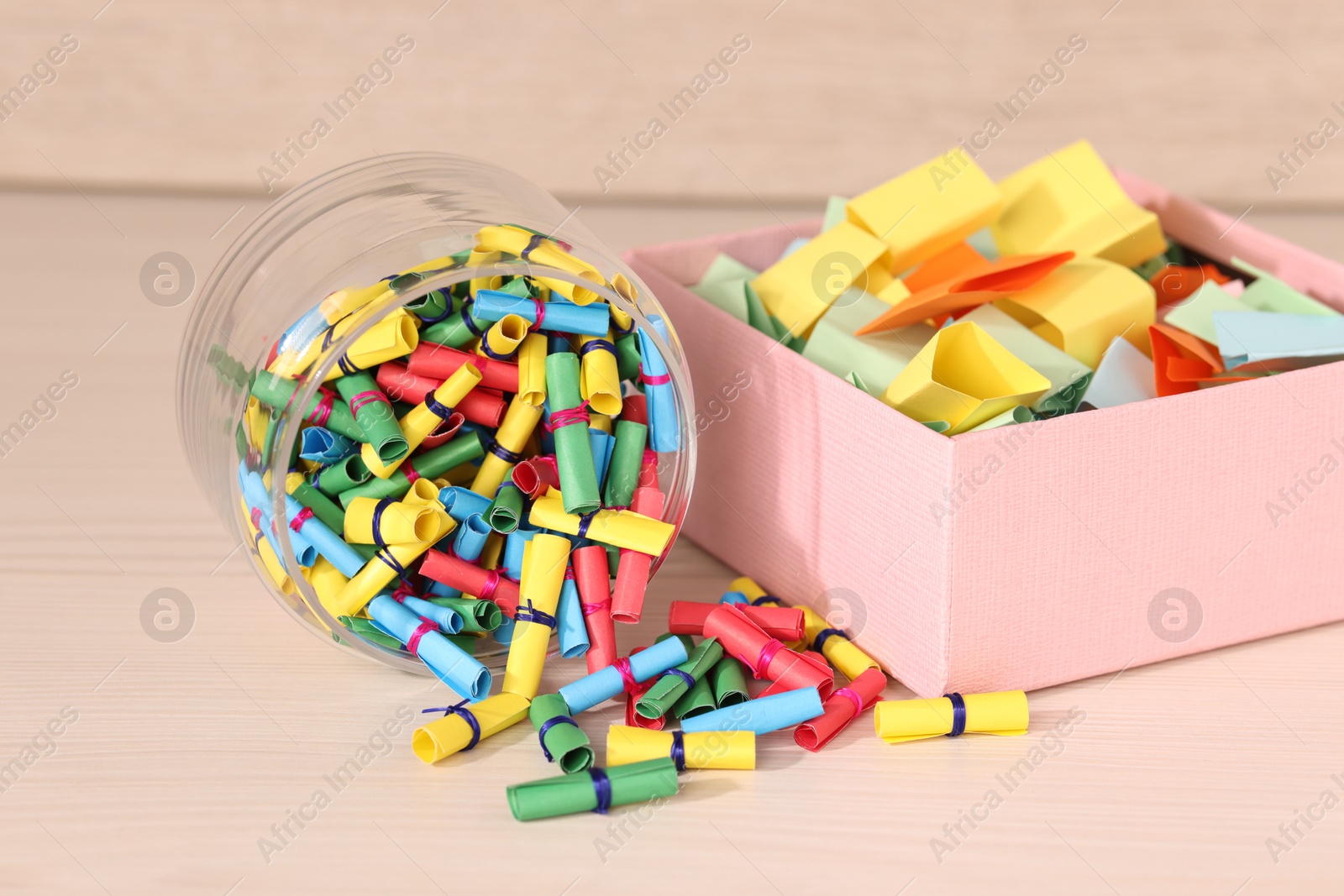 Color paper pieces on light wooden table, closeup Photo of Color paper pieces on light wooden table, closeup