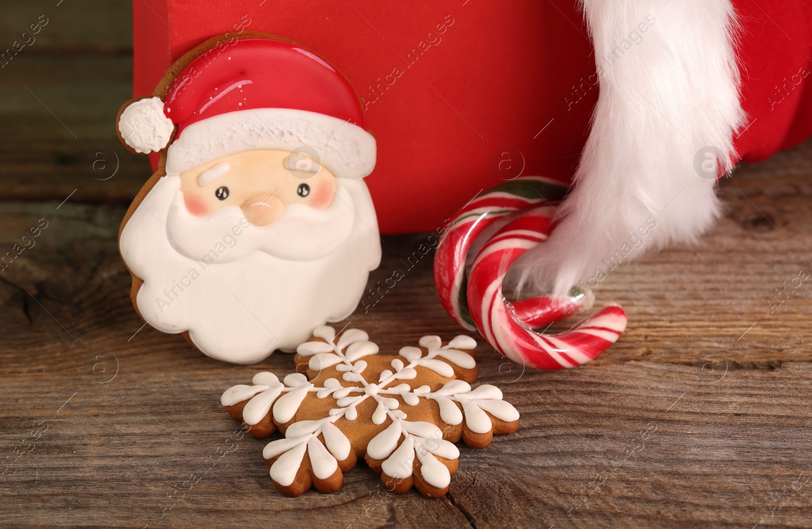 Saint Nicholas day tradition. Beautiful decorated gingerbread cookies and candy canes on wooden table, closeup Photo of Saint Nicholas day tradition. Beautiful decorated gingerbread cookies and candy canes on wooden table, closeup