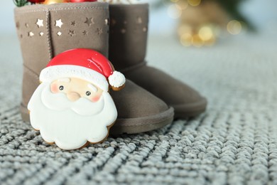 Photo of Saint Nicholas day tradition. Boots and gingerbread cookie on floor indoors, closeup