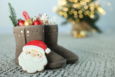 Photo of Saint Nicholas day tradition. Boots with sweets and festive decor on floor indoors