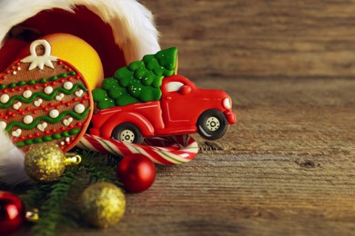 Photo of Saint Nicholas day tradition. Sweets and festive decor on wooden table, closeup. Space for text