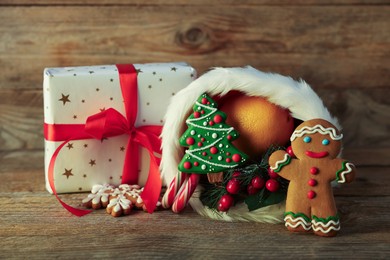 Photo of Saint Nicholas day tradition. Sweets, gift box and festive decor on wooden table