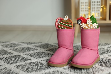 Photo of Saint Nicholas Day tradition. Child's boots with treats in room, space for text