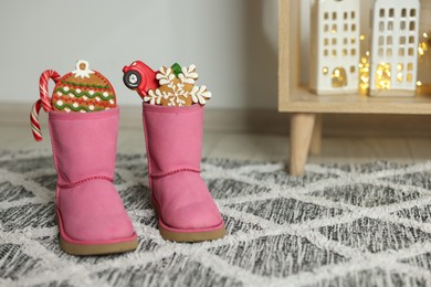 Photo of Saint Nicholas Day tradition. Child's boots with treats in room, space for text