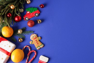 Photo of Saint Nicholas day. Fir tree, ornaments, gift box and treats on blue background, flat lay. Space for text