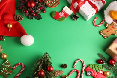 Photo of Saint Nicholas day. Different treats, festive decor and gift boxes on green background, flat lay. Space for text