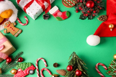 Photo of Saint Nicholas day. Different treats, festive decor and gift boxes on green background, flat lay. Space for text