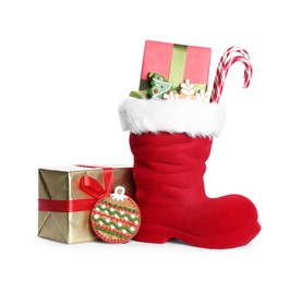 Photo of Happy Saint Nicholas day. Red boot with sweets and gift boxes isolated on white