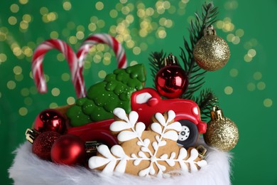 Photo of Happy Saint Nicholas day. Festive decor and sweets against green background with blurred lights, closeup