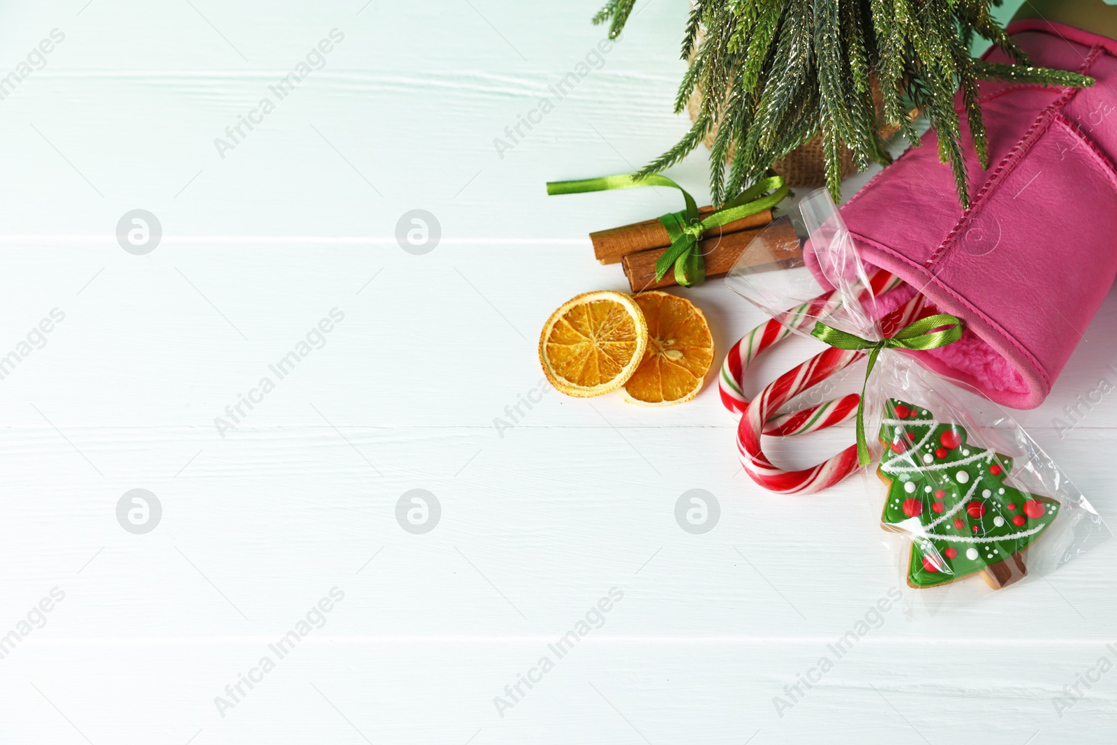 Happy Saint Nicholas day. Boot, festive decor and sweets on white wooden table, flat lay. Space for text Photo of Happy Saint Nicholas day. Boot, festive decor and sweets on white wooden table, flat lay. Space for text
