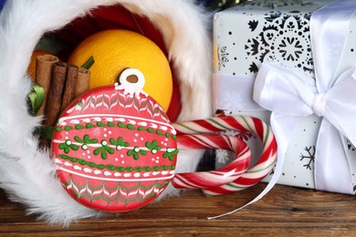 Photo of Happy Saint Nicholas day. Sweets and gift box on wooden table, closeup