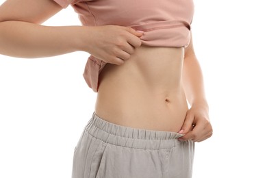 Photo of Woman with flat belly on white background, closeup