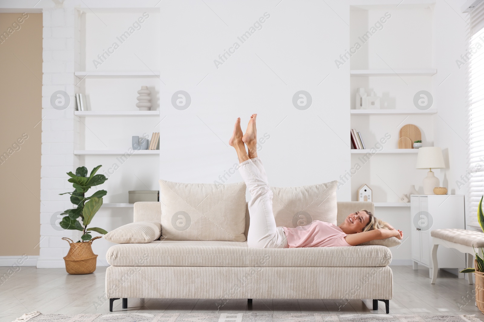 Beautiful woman relaxing on sofa at home Photo of Beautiful woman relaxing on sofa at home