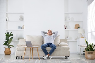 Photo of Young man relaxing on sofa at home